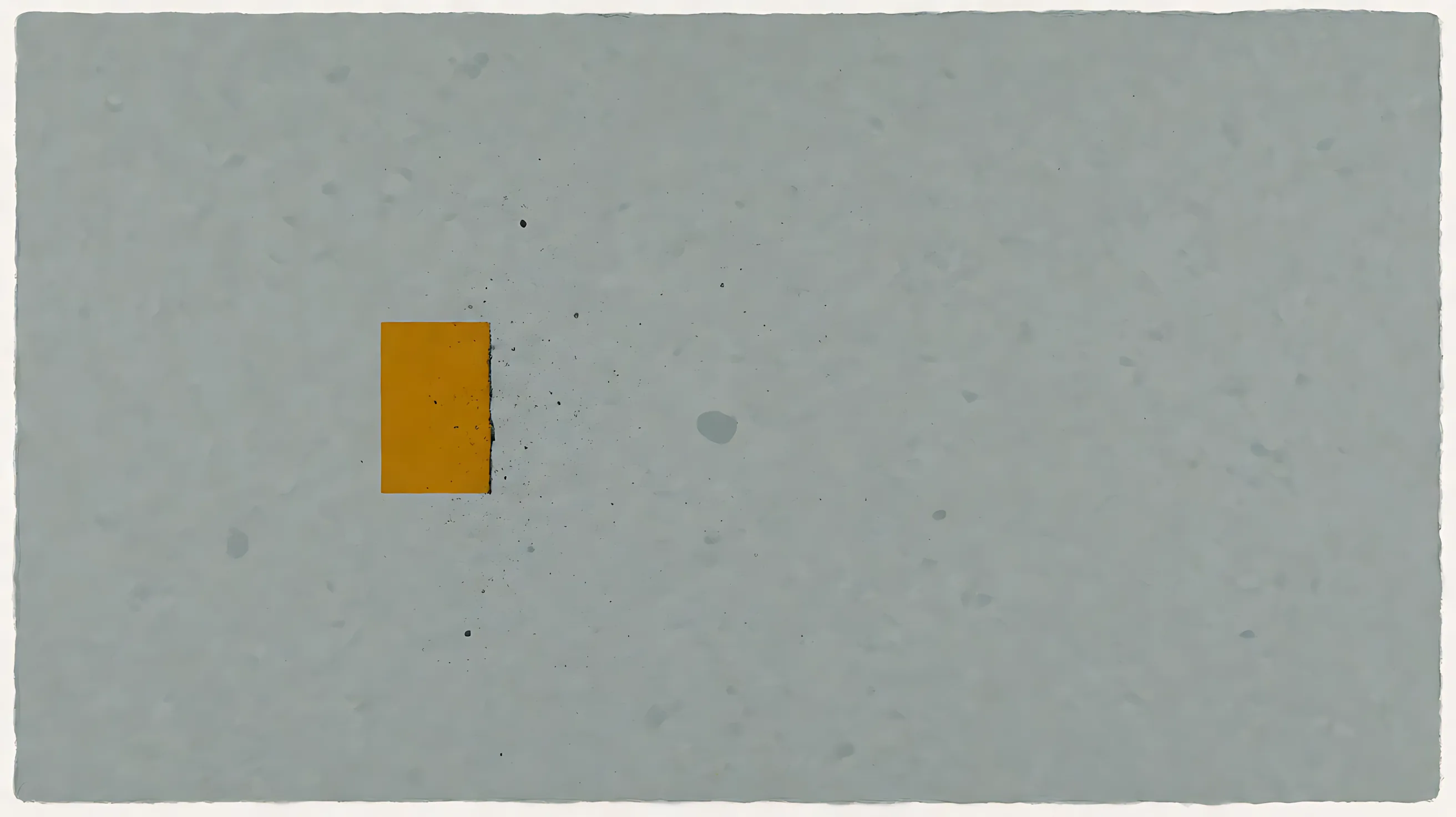A small ochre rectangle on gray paper, with a dark right edge and specks drifting right.