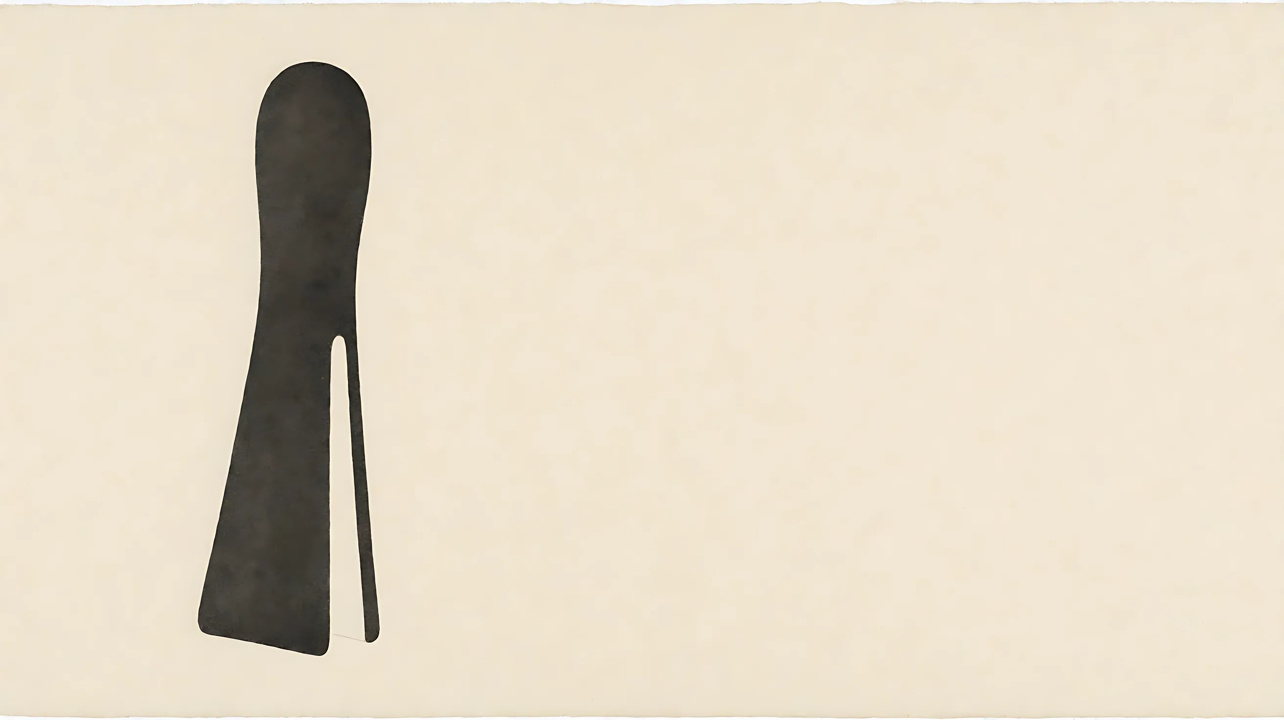 A tall charcoal shape on bone paper, split near the bottom so the paper shows through.