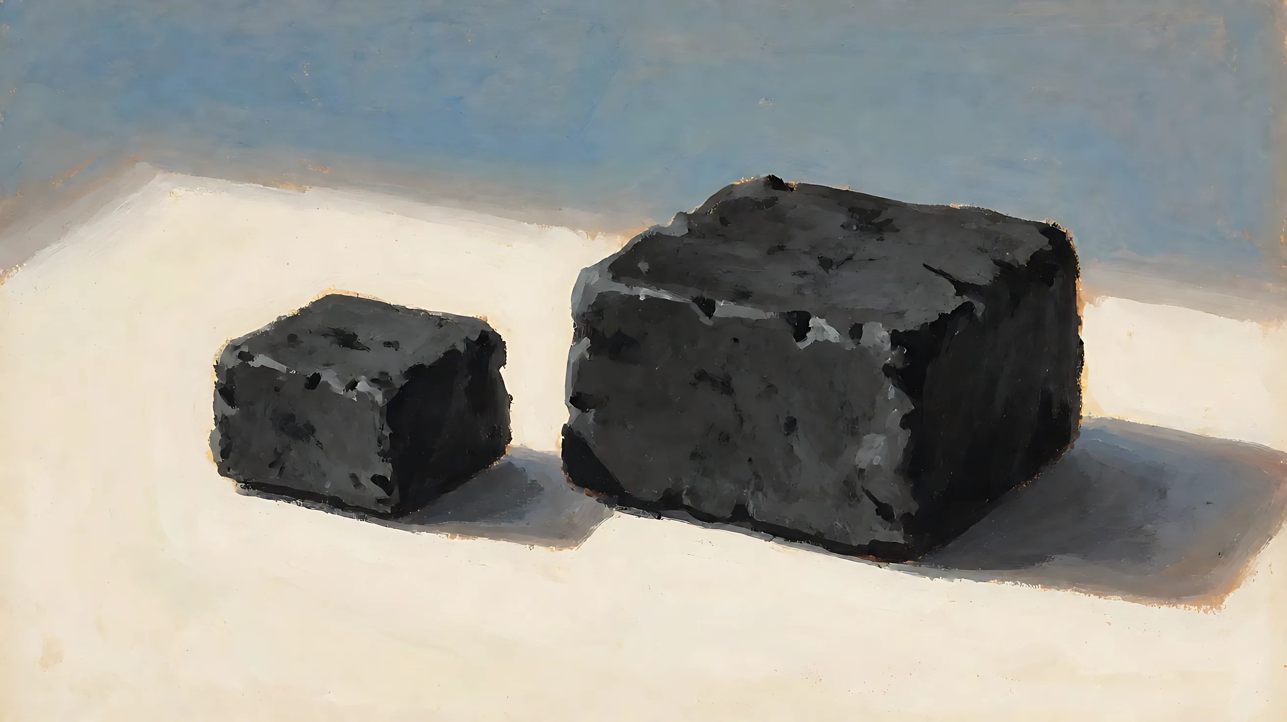 Two charcoal blocks, one small and one large.