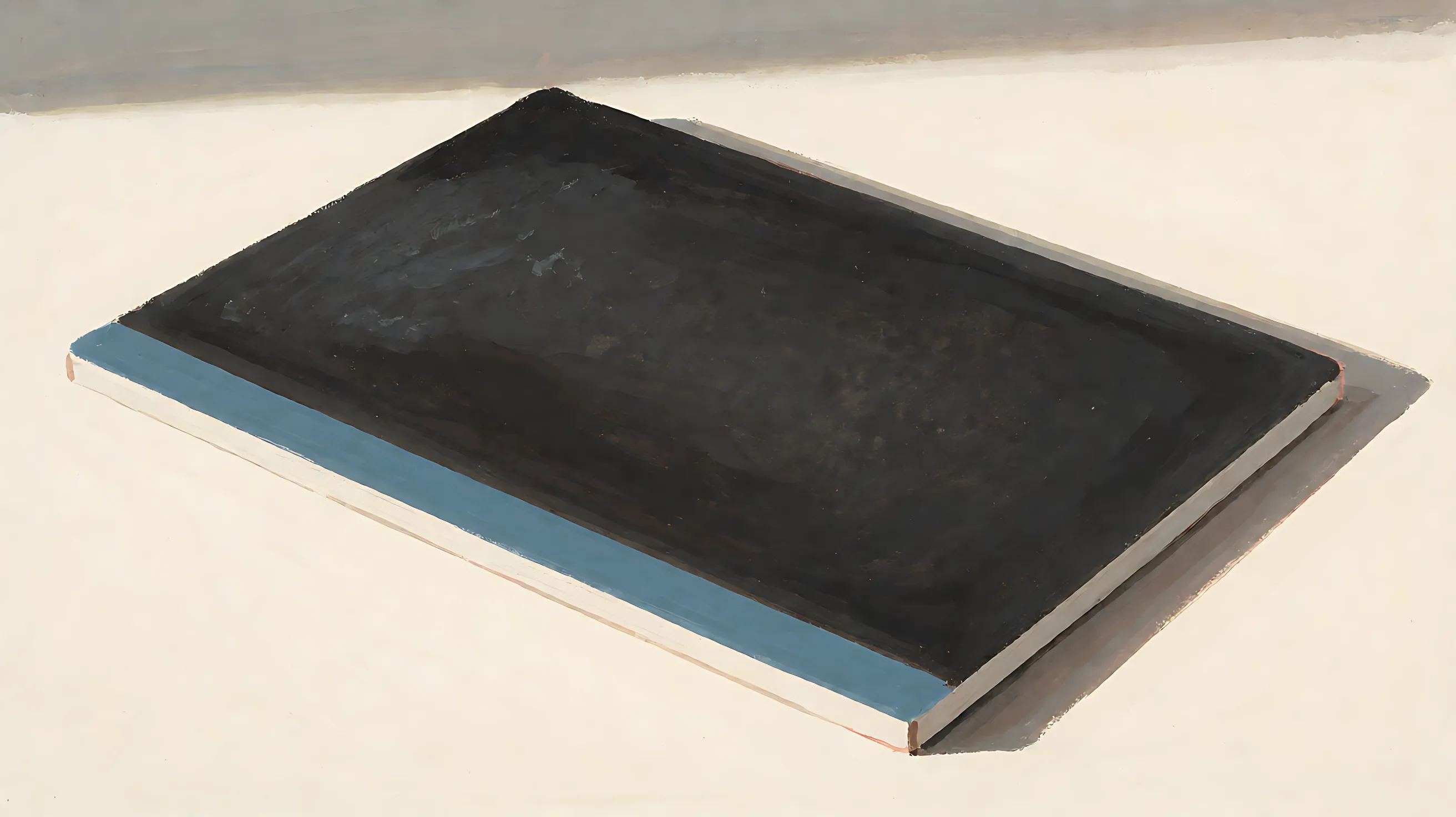 A flat board, charcoal face, one muted-blue edge
