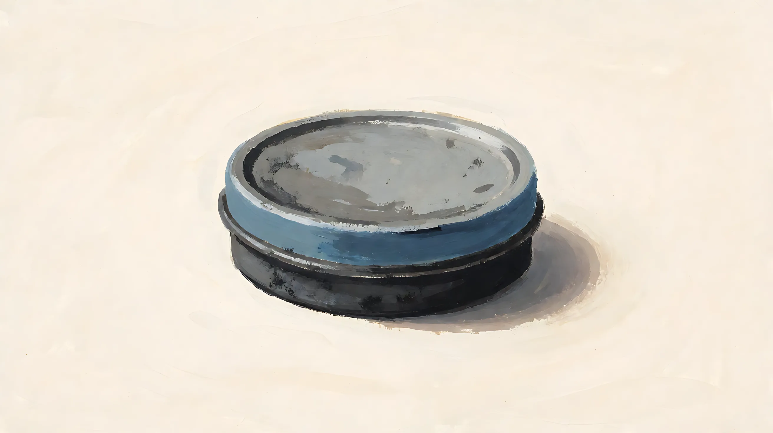 A closed charcoal tin, pale blank lid, one muted blue rim