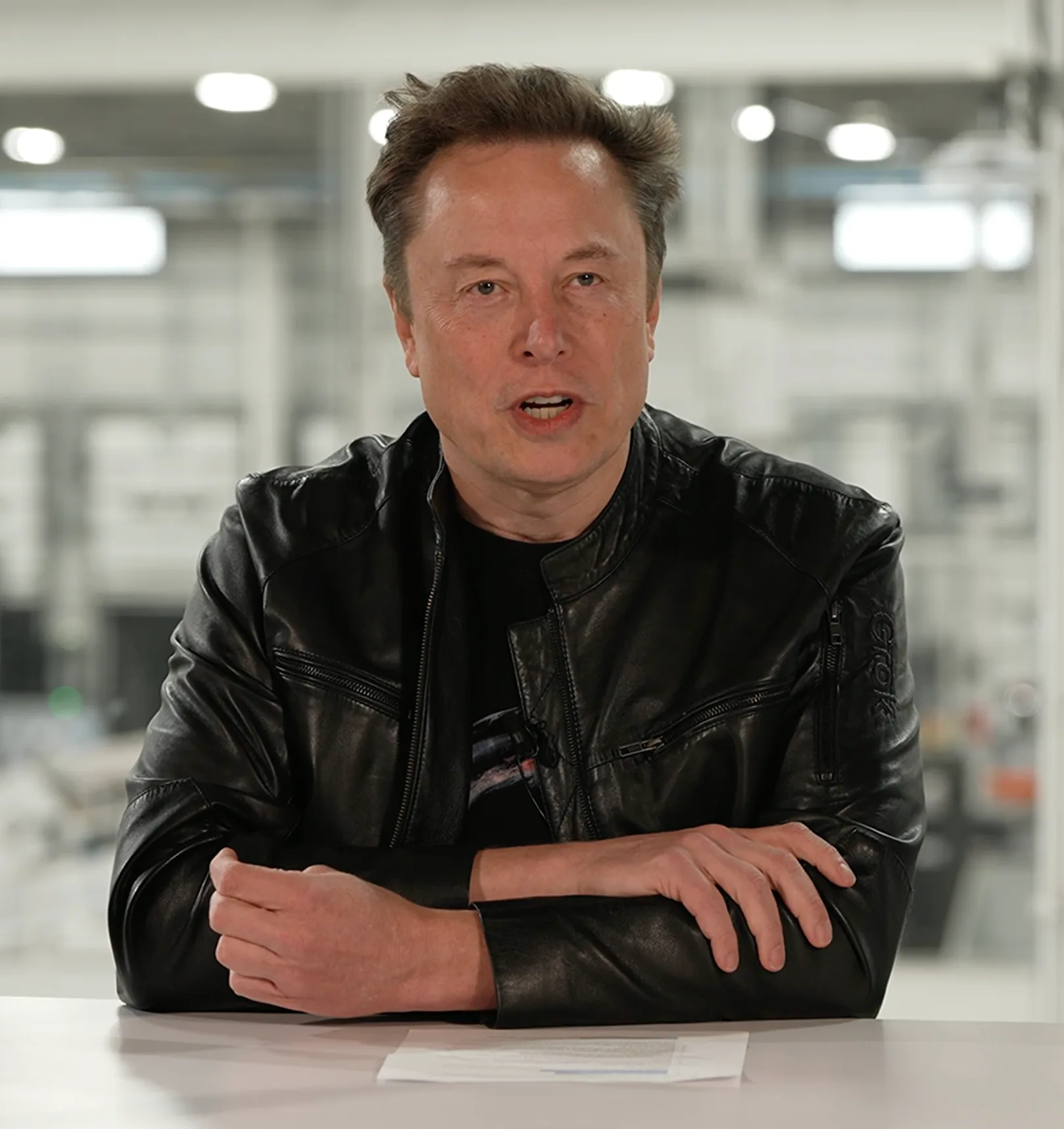 TechCrunch photograph of Elon Musk seated at a table