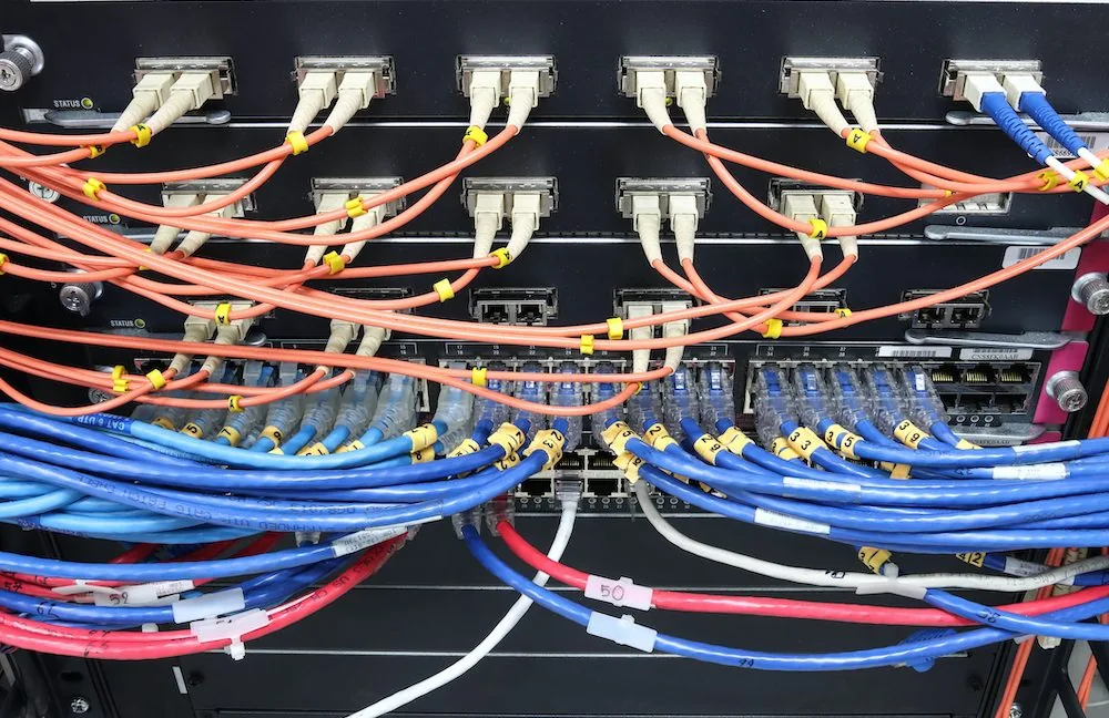 A network switch filled with cables, the photograph used in the article