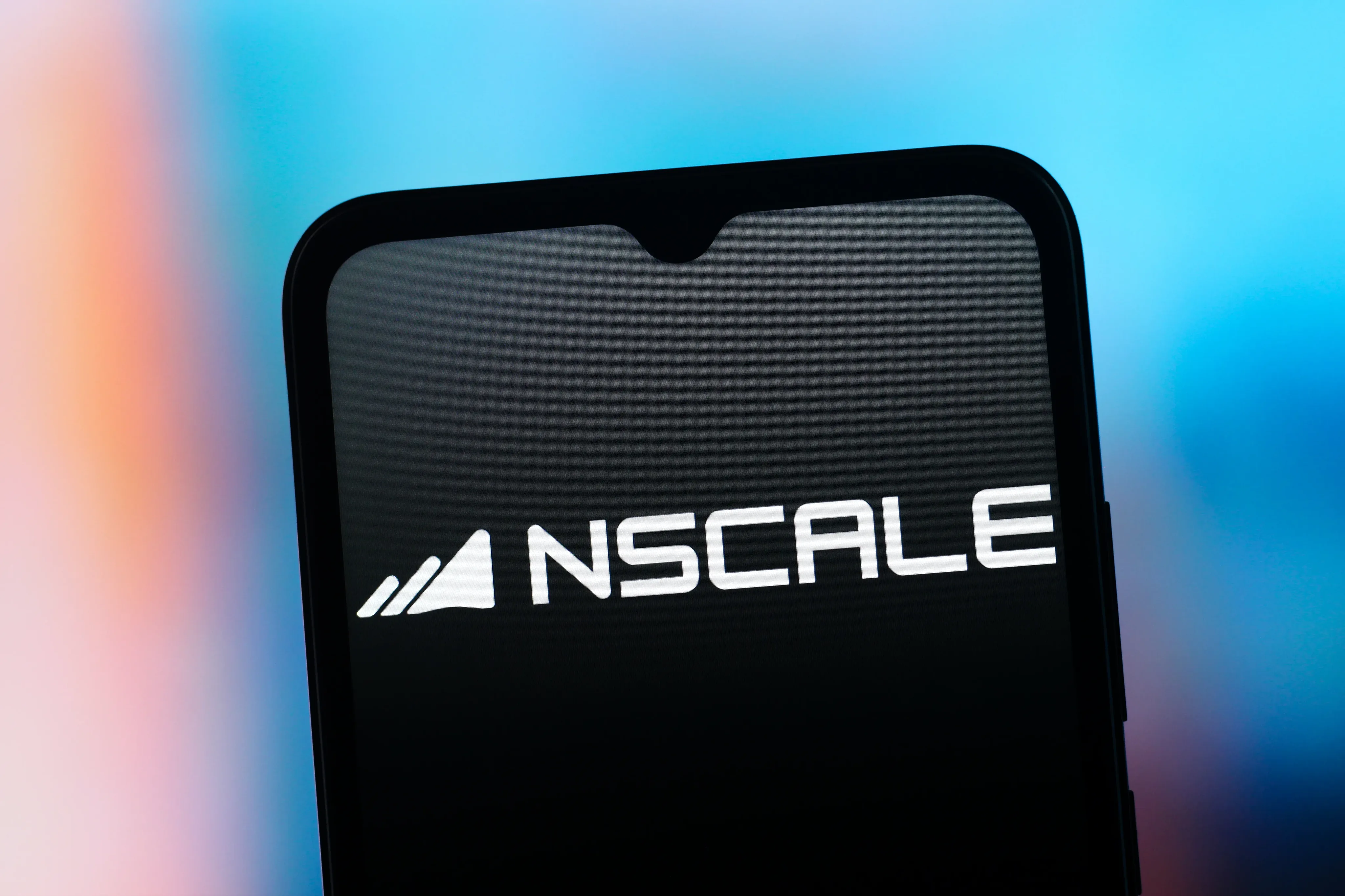 A phone screen showing the white Nscale mark against blue and orange light.