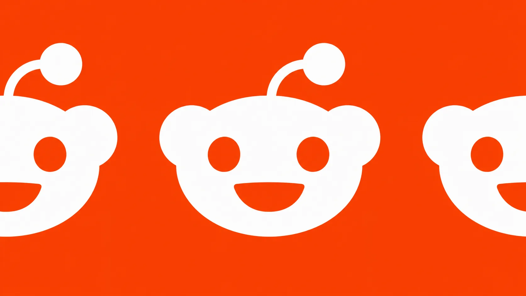 橙色底上重复排列的 Reddit 白色标志。